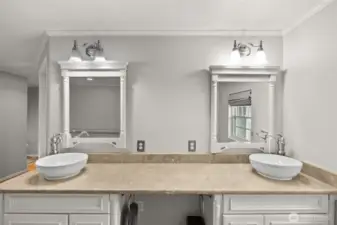 Beautiful vanity space with dual sinks and modern lighting.
