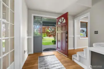 Welcoming entryway with natural light and warm wood floors.