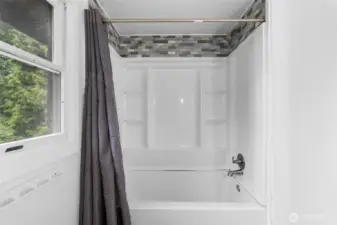 Bathroom with full size tub and shower.