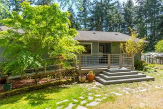 The front entrance can be approached in two way, notice the ramp which leads to a garage door entrance as well. The sunny front deck has plenty of space for entertainment and gatherings.