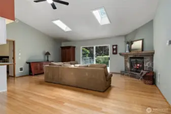 The foyer, opens into a large living area, with vaulted ceilings and skylights.