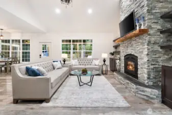 Soaring cathedral ceiling with wood fireplace insert and radiant heat flooring.