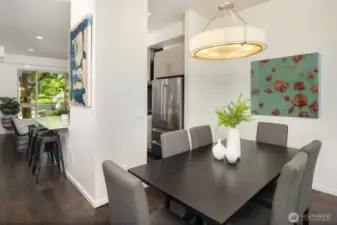 Dinning area with large windows showcasing the city and step onto the private balcony to enjoy amazing sunsets.