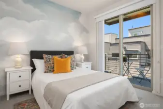 Upstairs bedroom with private balcony and western facing view of the city skyline and gorgeous sunsets.