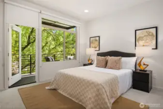 Primary suite and bathroom with private balcony and beautiful greenery.