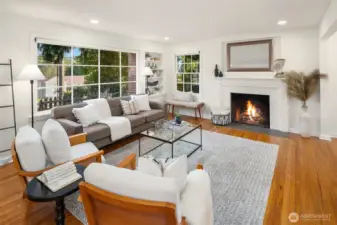Living room with hardwood floors and wood burning fireplace