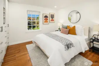 Primary bedroom with attached bathroom and built in closets