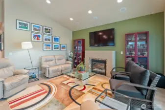 gas fireplace in living room; mounted TV stays with the home- surround sound too!