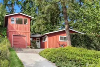 Perched up off the quiet street, this sweet rambler is one of a kind!