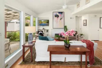 Another view of the living room and shows the gorgeous wall of windows that looks out to a beautiful and flat backyard with a covered patio. Perfection.