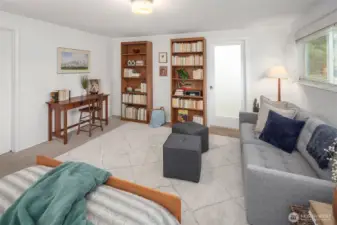 Another view of the primary suite, looking towards the walk-in closet and en suite bathroom