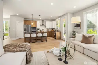 From living/great room into the kitchen.  White wood blinds throughout the home.