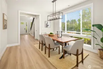 From kitchen into the dining room and grand foyer. This home is flooded with natural light.