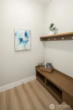 Greeting you from the garage, a mudroom for dropped school bags, coats and shoes.