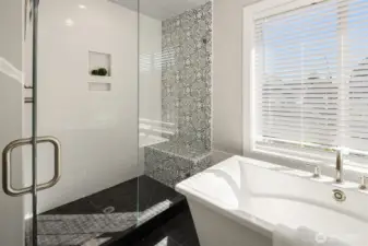 Oversized walk-in shower with built-in shelving.