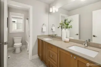 Guest bath has seperation for toilet and shower, whit quartz with dual vanity.