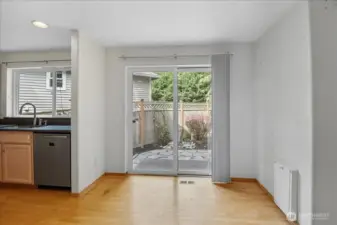 Cozy breakfast nook and a slider that opens up to the fenced back yard.