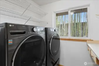 This is the laundry room that also has some storage and a folding shelf.