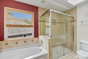 There is a luxurious soaking tub and spacious shower.