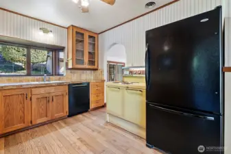 Kitchen features a dishwasher, refrigerator and vintage electric range