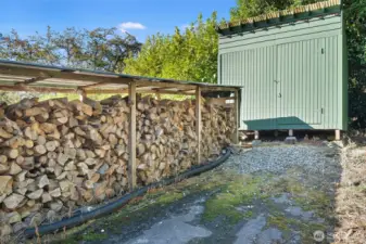 Covered wood storage and 12'x18' utility shed
