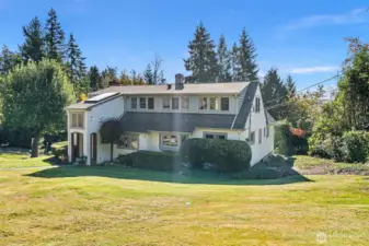 Rolling lawn surrounds the house