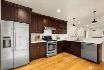 Gas cooktop and stainless steel appliances in the very functional kitchen.