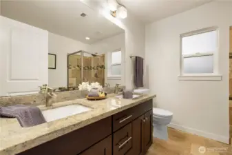 Ensuite bathroom off the primary has dual sink, separate shower and tub.