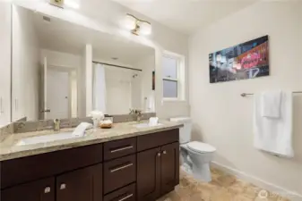 Second bathroom upstairs also has dual sinks and solid countertops.