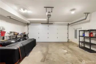 Two car garage has a brand new insulated garage door.