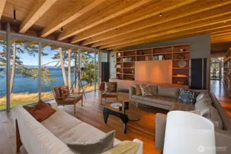 The main living area is framed by dramatic floor-to-ceiling glass walls overlooking Haro Strait, allowing the surrounding shoreline and ever-changing water views to become part of the home’s design.