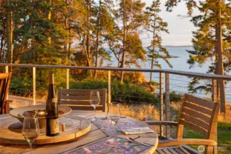 Enjoy outdoor dining on the expansive deck where panoramic water views, warm sunset light, and coastal breezes create an unforgettable setting for evenings on San Juan Island’s west side waterfront.