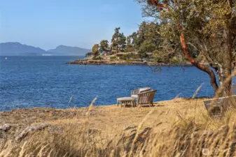A peaceful seating area set near the shoreline invites quiet moments overlooking San Juan Island’s rugged coastline and expansive open water.