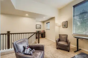 loft area open to work space with desk.