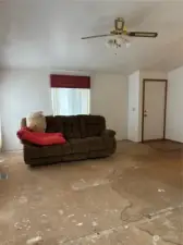 Livingroom. As you can see there was water damage from the wet carpet. The carpet has been removed, as previously stated, and the carpet needs to be replaced. There is some damage to the subfloors. The house is priced according to it's condition and is being sold as-is