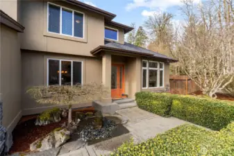 Front yard features a water fountain and mature landscaping.