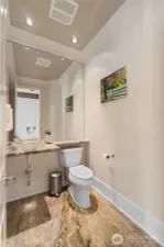 Guest Bathroom features granite slab floor and floating countertop