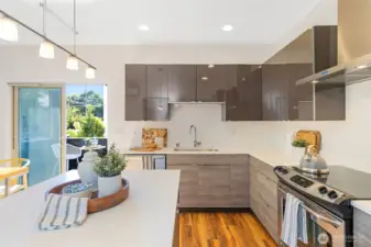 A kitchen fit for a chef—featuring quartz counters, stainless steel appliances, ample cabinetry, and a walk-in pantry.