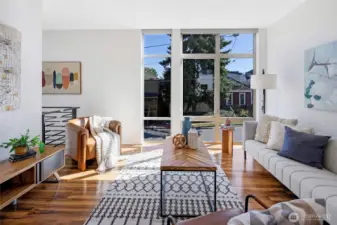 Sun-filled living room with south-facing floor-to-ceiling windows—ideal for movie nights or curling up with a book.