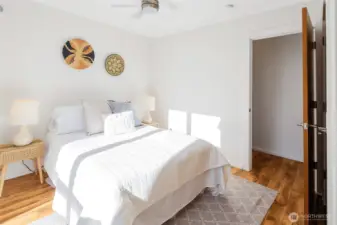 West-facing bedroom with a serene, modern feel and large windows—ideal for soaking up sunsets.