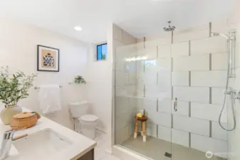 The primary suite’s en-suite ¾ bath offers a spa-like retreat with a rainfall shower—perfect for unwinding after a long day.