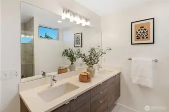 A double vanity with sleek finishes and ample storage makes busy mornings simple and stress-free.