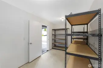 Bonus storage room off the garage with shelving—ideal for bikes, outdoor gear, or seasonal items.