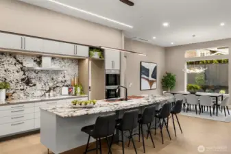 Grand Quartz Island w/ Rich Warm Veining & Inundated Sink, Built for Everyday Ease.