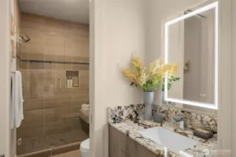 Guest Suite Bath w/ Large Shower, Bench Seat, Touch Backlit Mirror & Warm Tones.
