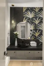 Chic Powder Bath w/ Floating Vanity, Vessel Sink, Wall-Hung Toilet & Boutique Wallpaper.