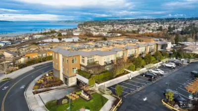An aerial view of 50 Pine in Edmonds, perched above the bluff with beautiful west-facing views of Puget Sound, the marina, and ferries passing by—capturing the serene coastal beauty of Edmonds living.