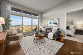 A beautifully staged living room filled with natural light, offering an open, airy feel with plenty of space to relax or entertain. Clean lines, warm tones, and thoughtful design make it feel both comfortable and inviting.