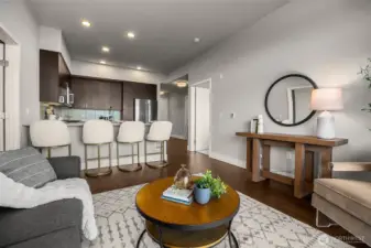 A spacious, open-concept living room with soaring ceilings, perfect for entertaining. The airy layout flows seamlessly into the adjoining spaces, creating a bright and inviting atmosphere.