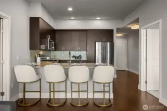 A bright, functional kitchen featuring ample storage with cabinets and pantry space, designed for both everyday cooking and effortless entertaining.